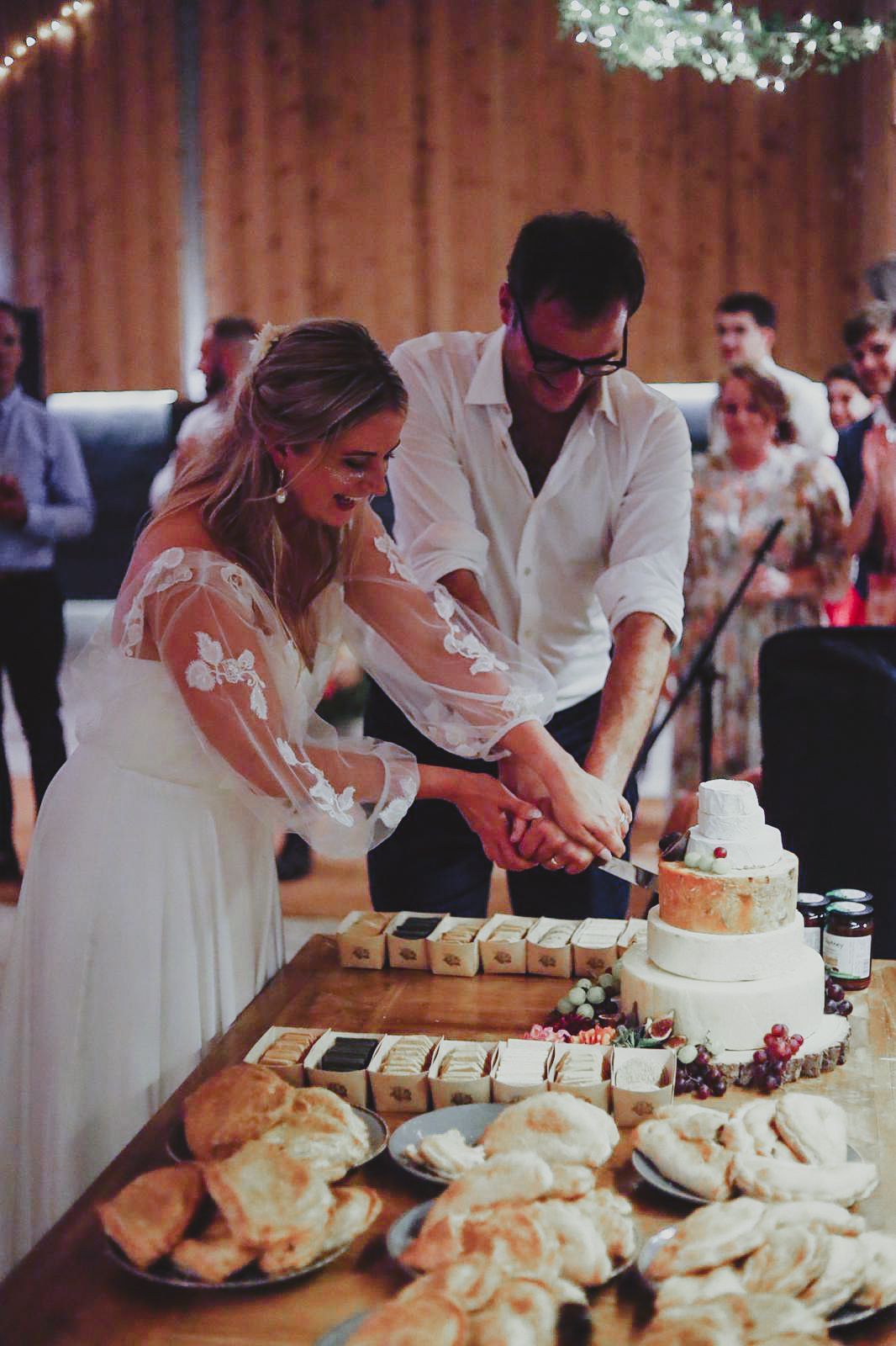 Wedding couple cutting the cake at Barn Wedding venue at The Grain Store Devon