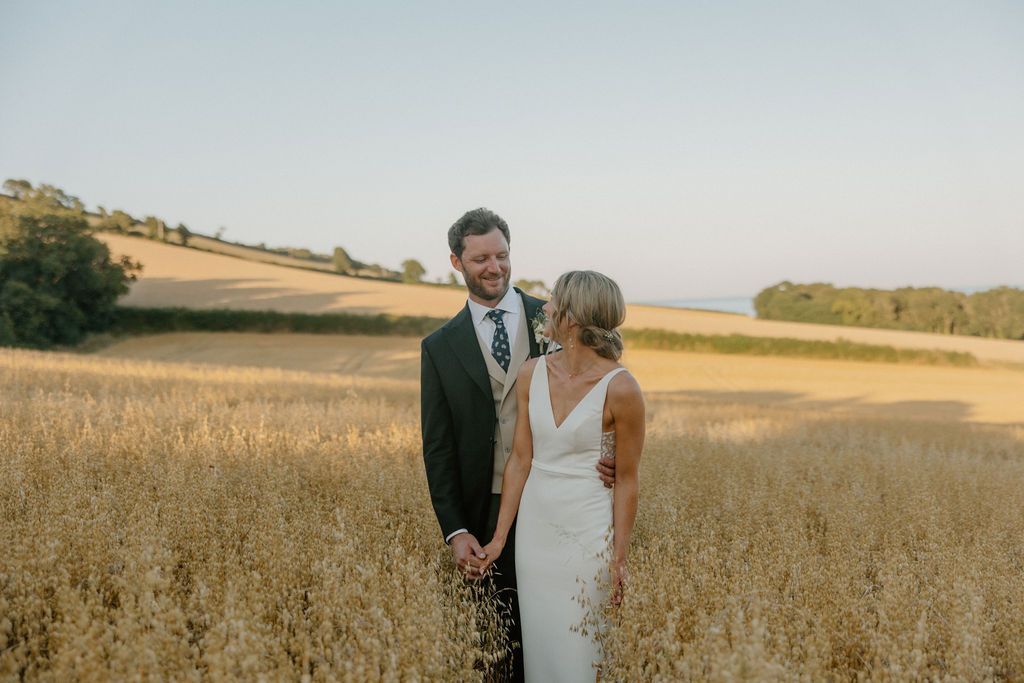 Wedding couple in the wheat fields outside The Grain Store Devon