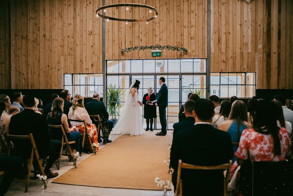 Wedding couple getting married in the Barn at The Grain Store