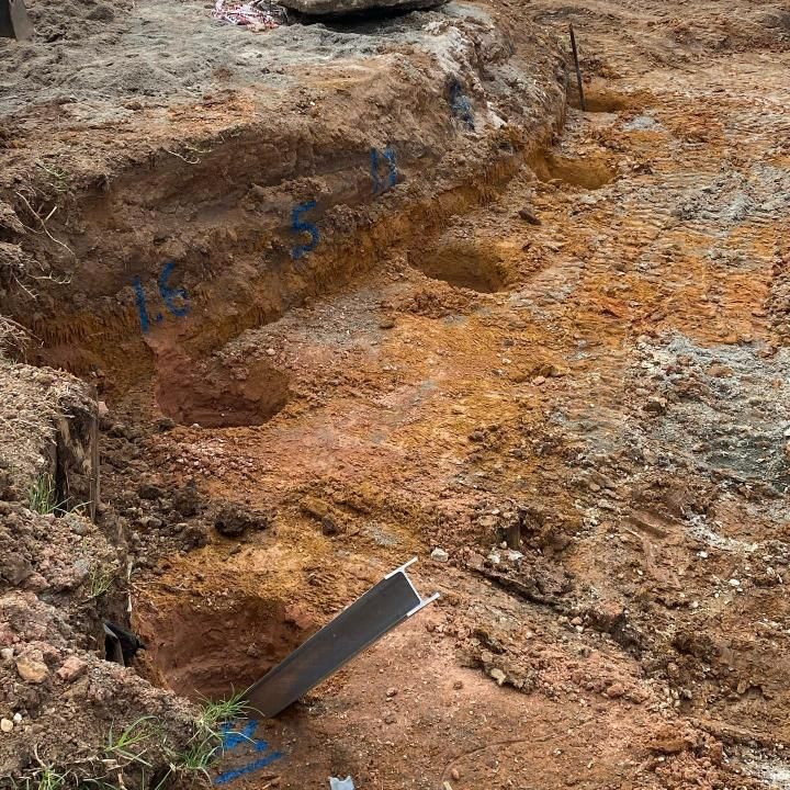 Large Pile of Dirt With a Metal Bar Sticking Out of It — Donaldson Plumbing & Excavations in Wodonga, VIC