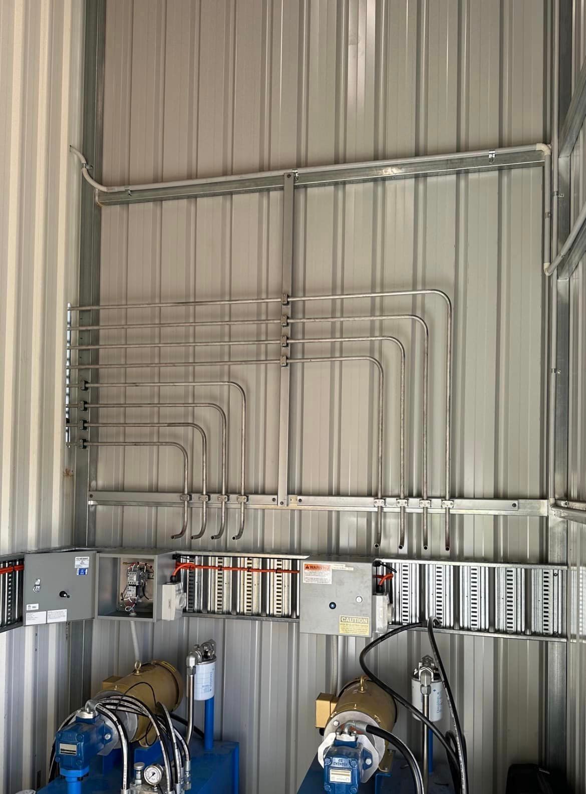 Room With a Lot of Pipes Hanging on the Wall — Donaldson Plumbing & Excavations in Kergunyah, VIC