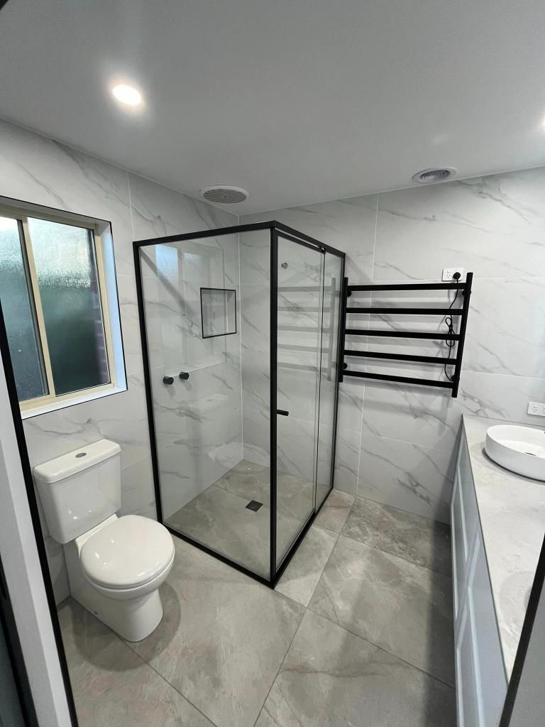 Modern Bathroom With Black-Framed Shower, and Heated Towel Rack — Donaldson Plumbing & Excavations in Kiewa, VIC