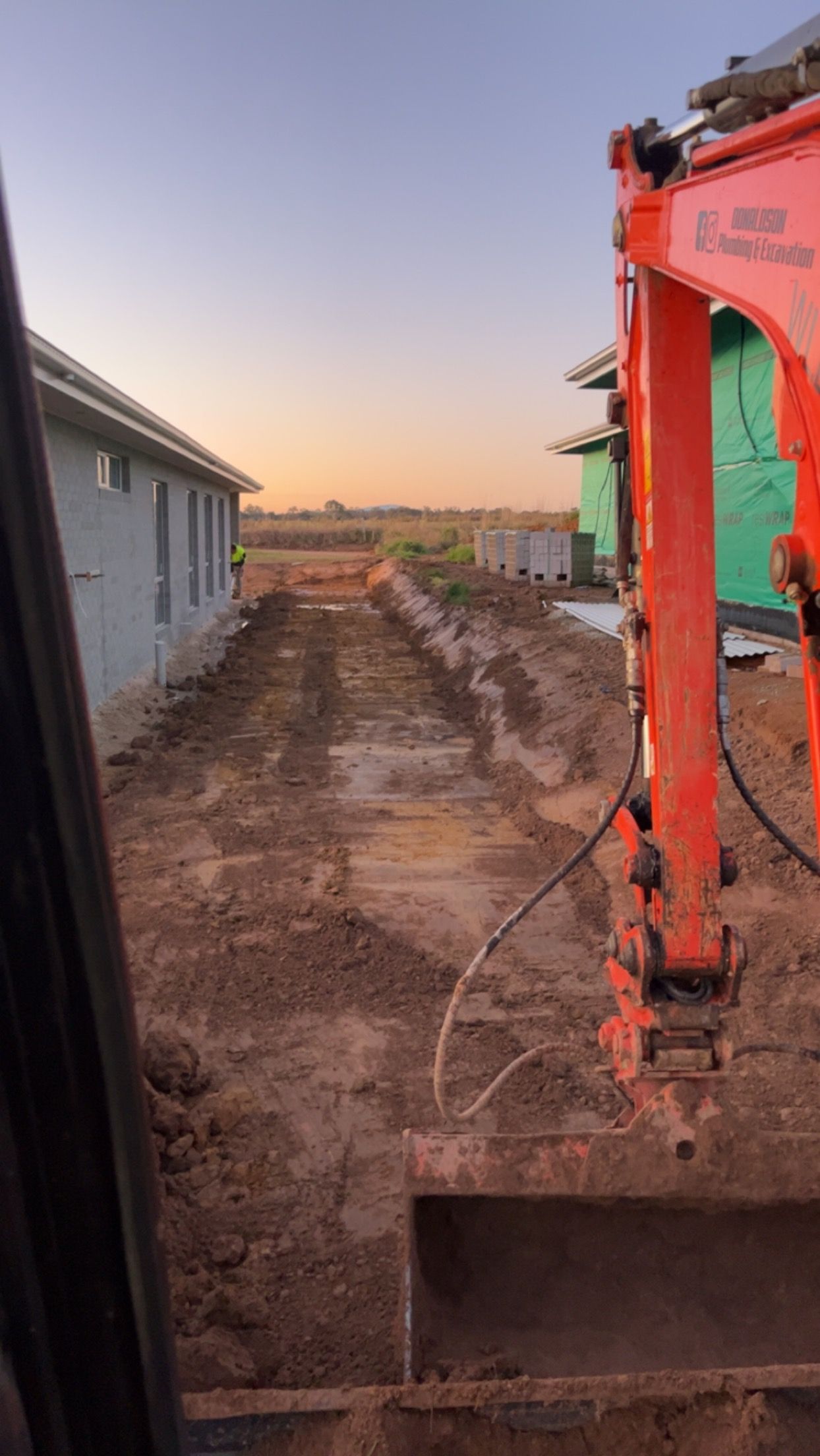 Excavator Digging a Trench in a Construction Site — Donaldson Plumbing & Excavations in Baranduda, VIC