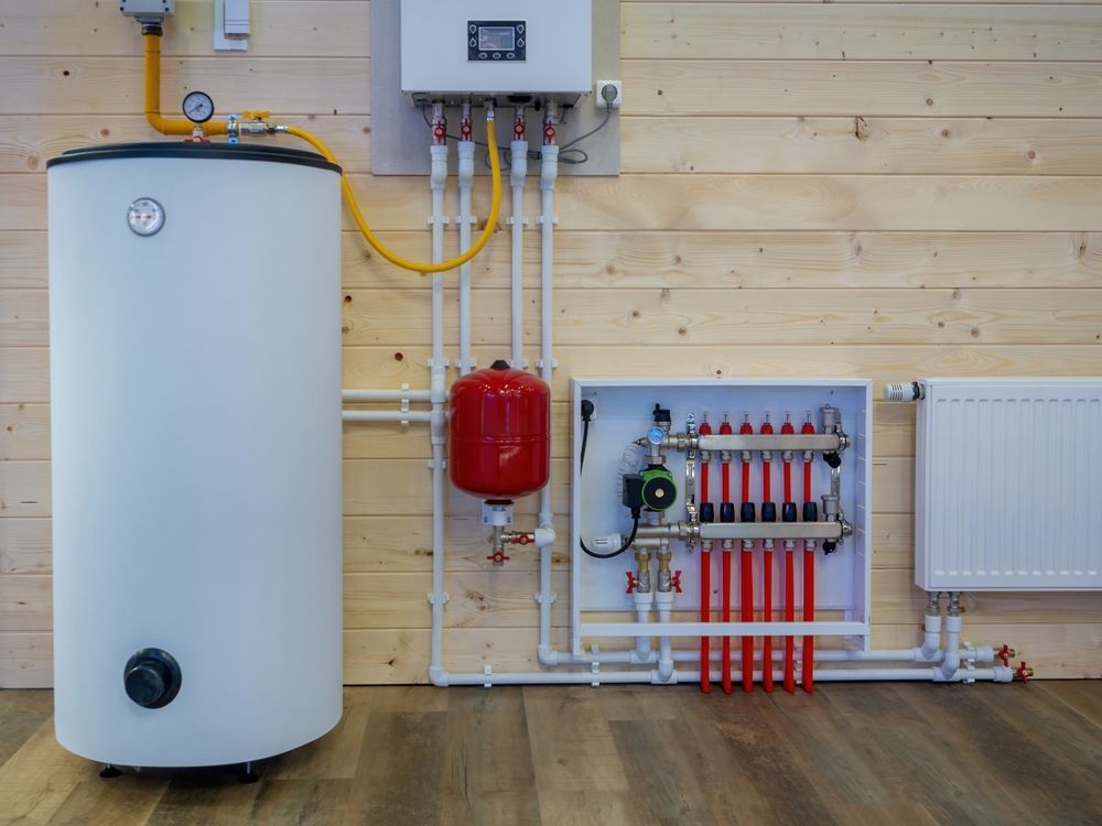 White Water Heater and Associated Plumbing on Wooden Wall — Donaldson Plumbing & Excavations in Baranduda, VIC