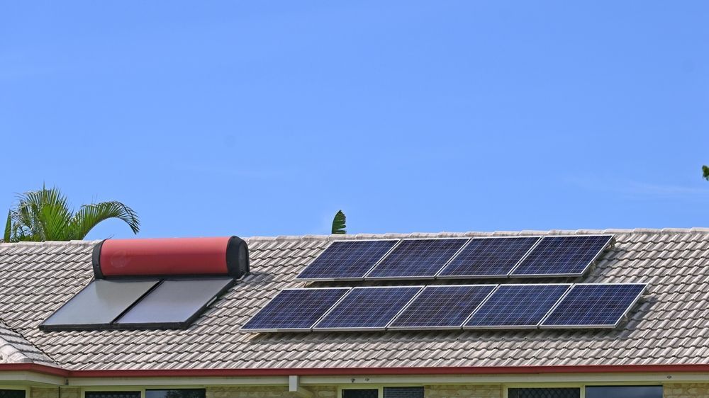 Solar Panels and a Water Heater on a Tiled Roof — Donaldson Plumbing & Excavations in Chiltern, VIC