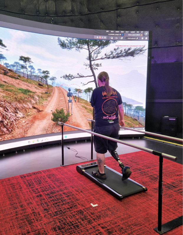 Person using a VR treadmill inside a curved virtual reality simulator room.