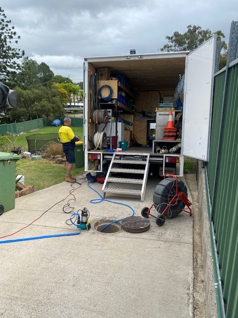 A Truck is Parked in a Driveway Next to a Brick Sidewalk — FlowWise in Maroochydore, QLD