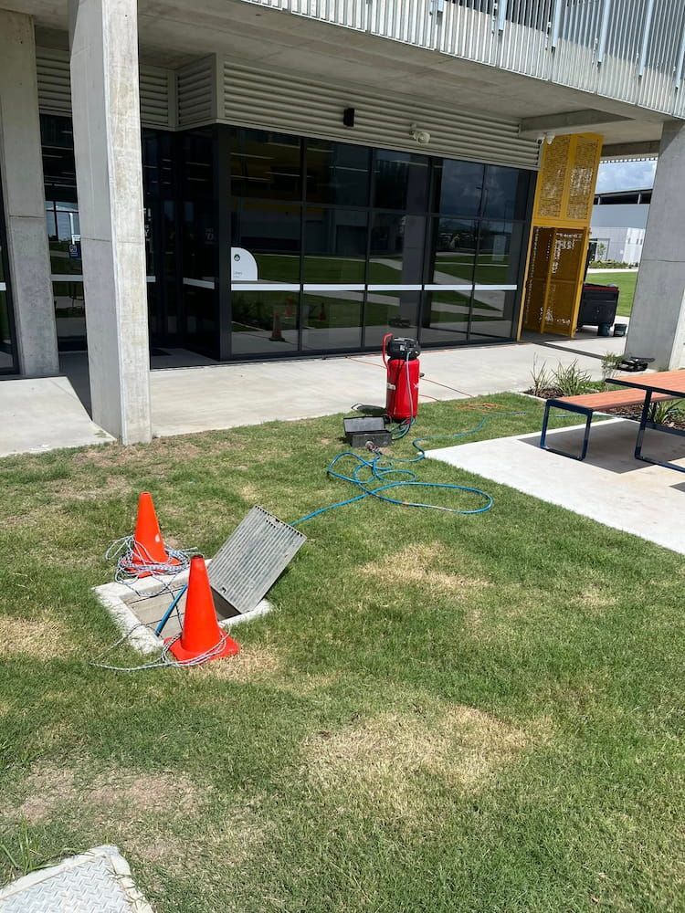 A Fire Hydrant is Sitting in the Grass in Front of a Building — FlowWise in Maroochydore, QLD