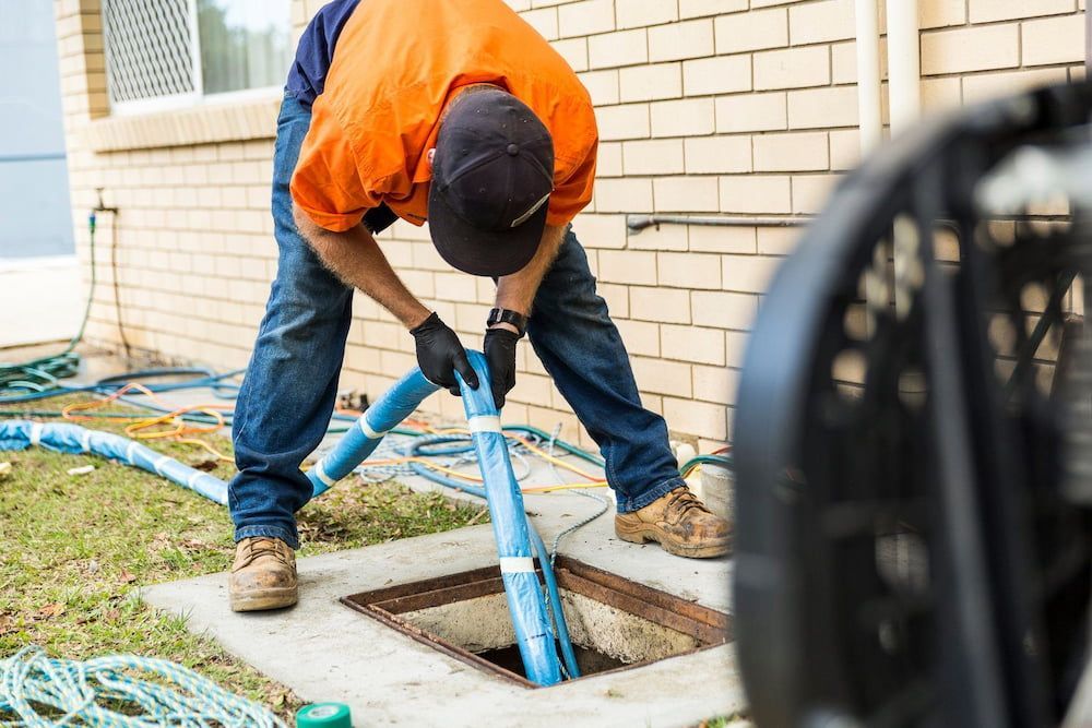 A Manhole Cover is Being Installed on the Side of the Road — FlowWise in Maroochydore, QLD