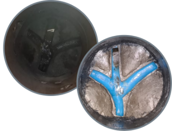 Two dark, spherical objects, one intact, the other cut open to reveal a blue, Y-shaped interior within a silver substance. — FlowWise in Maroochydore, QLD