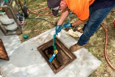 Plumber checking underground pipes