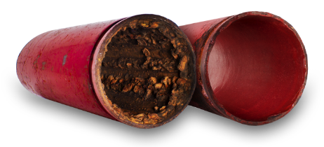 Two red pipes. One is clogged with dark brown buildup, the other is clean inside. — FlowWise in Maroochydore, QLD