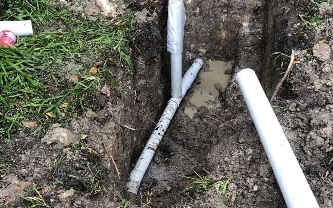 A Couple of White Pipes Are Laying in the Dirt — FlowWise in Maroochydore, QLD