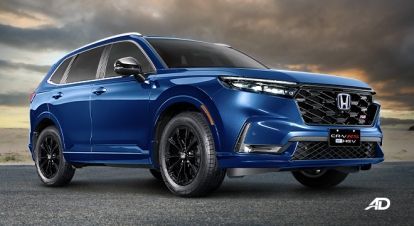 Blue Honda SUV with black wheels parked on a road at sunset under a cloudy sky