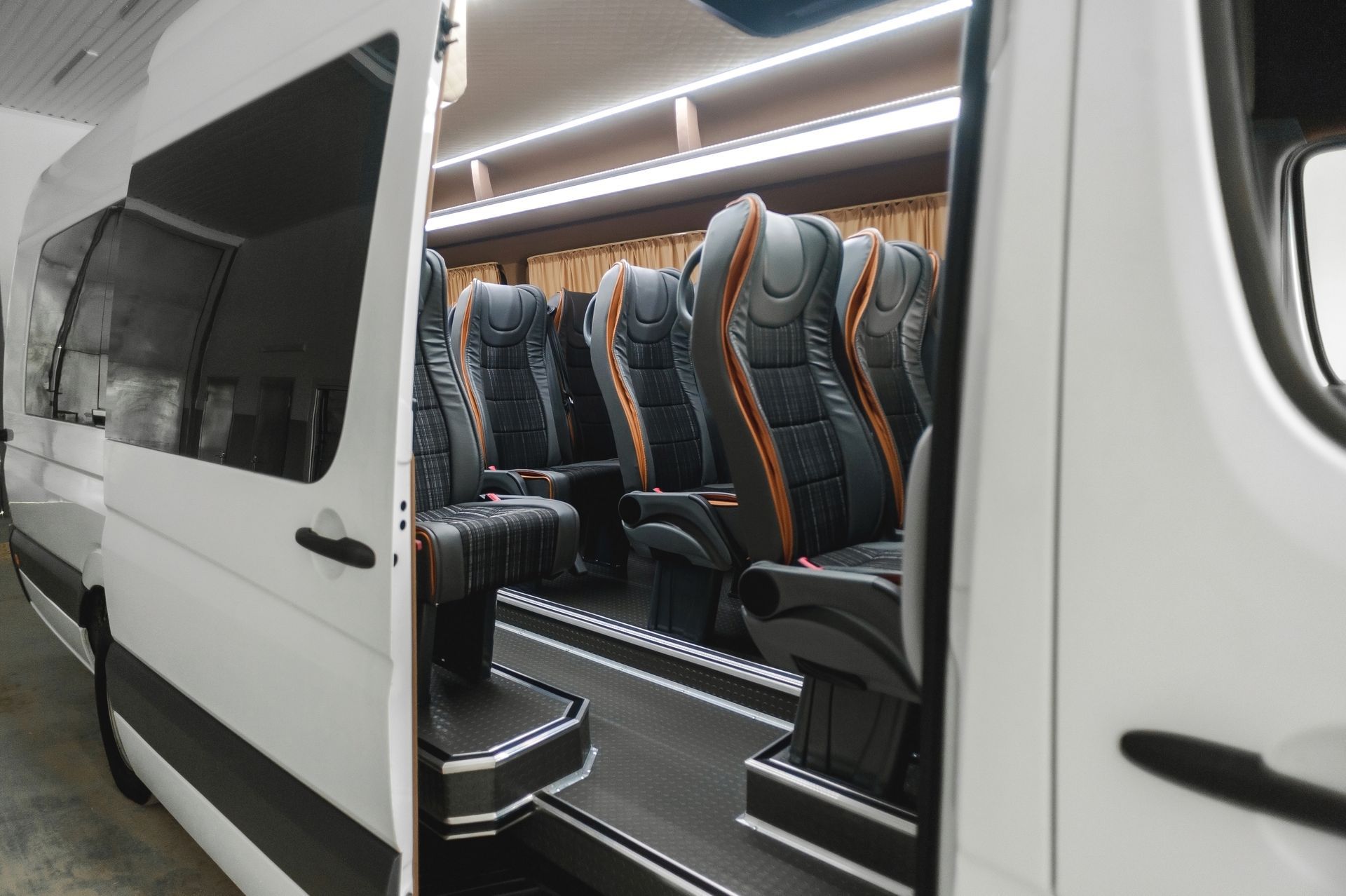 The inside of a white van with the door open.