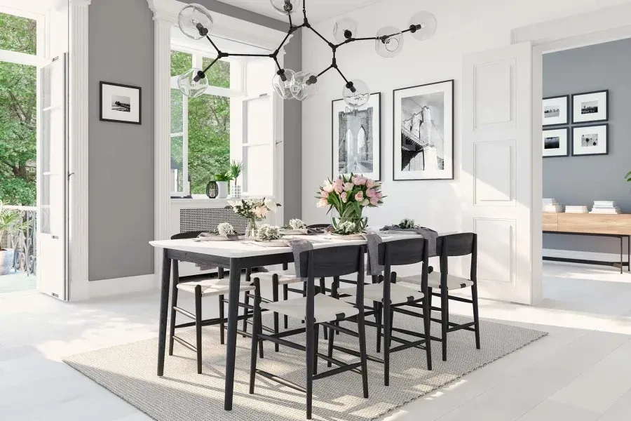 A dining room with a table and chairs and a rug.