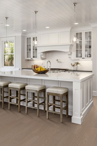 A kitchen with a large island and stools