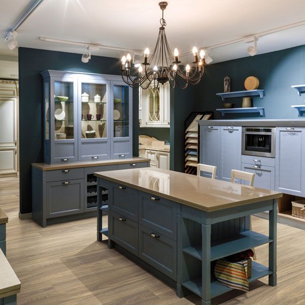 A kitchen with blue cabinets and a large island