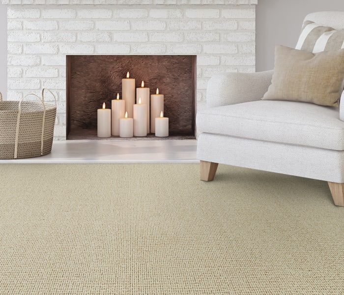 A living room with a fireplace filled with candles and a chair