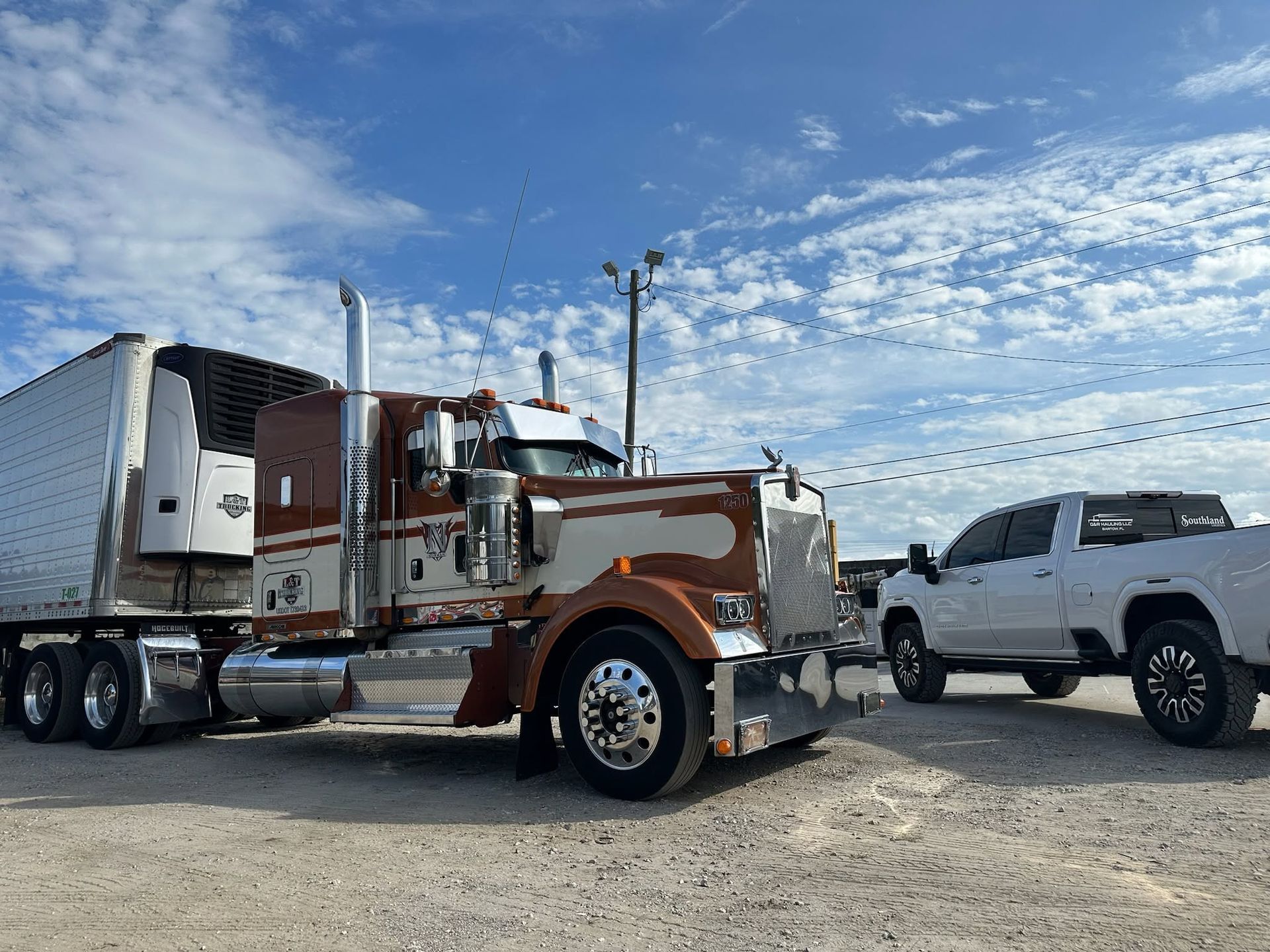Truck repair shop with a white truck, open engine bay, and parts on a red-covered table