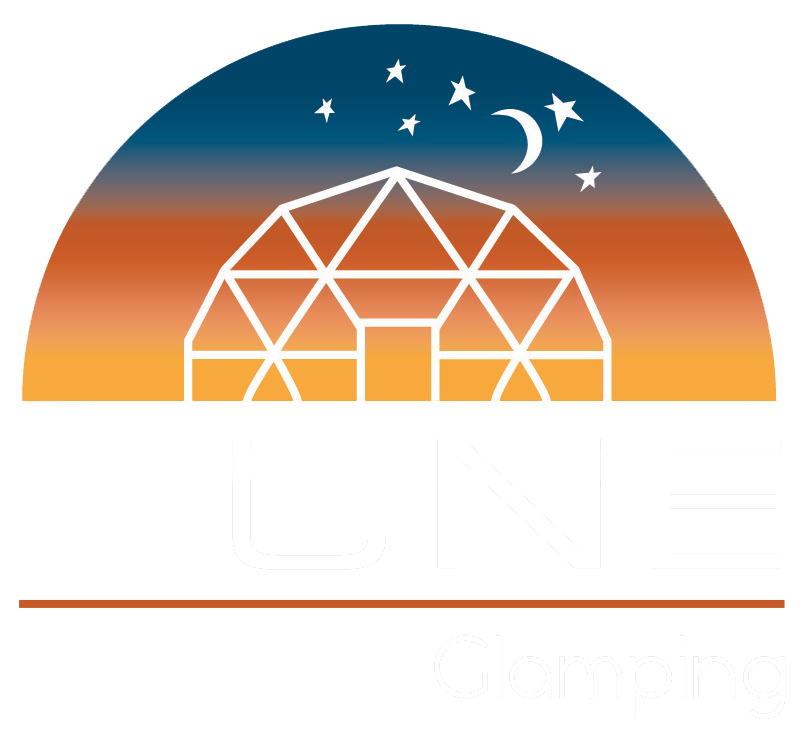Geodesic dome under a starry crescent moon at sunset over an orange horizon