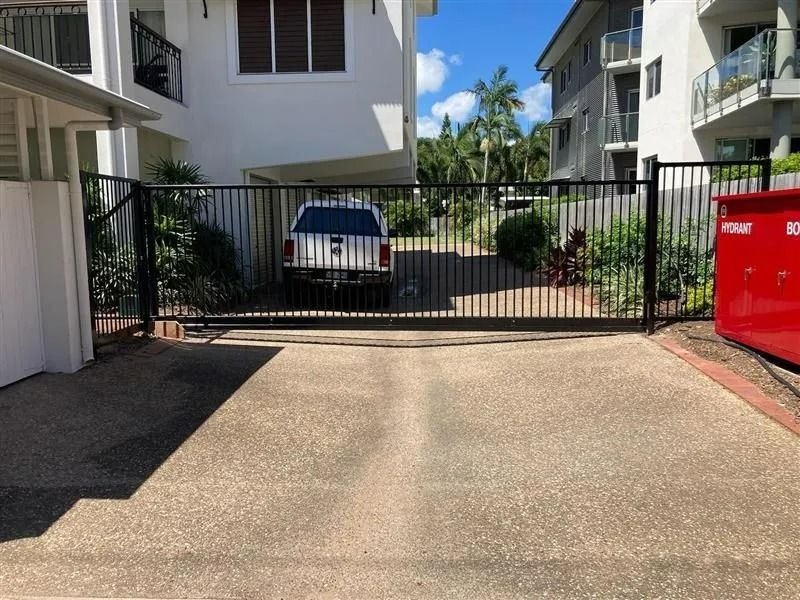 Black Gate in Front of a Driveway, With a White Truck Parked Behind It — Gate-O-Matic in Garbutt, QLD