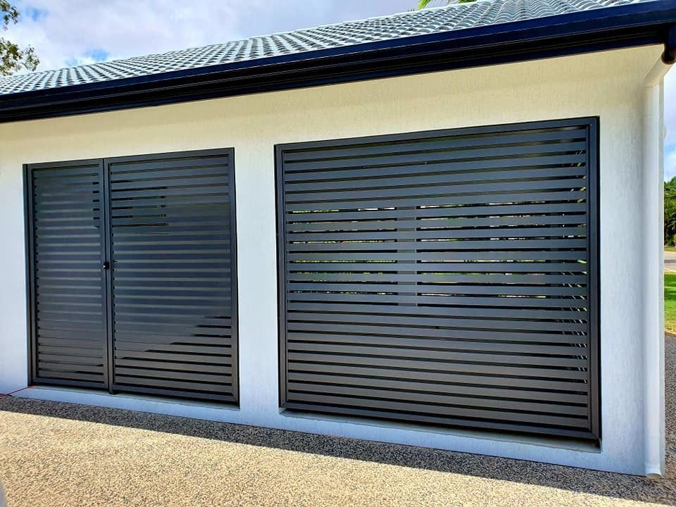 A Modern White Building With Two Dark Grey Horizontal-slat Privacy Screens — Gate-O-Matic in Garbutt, QLD