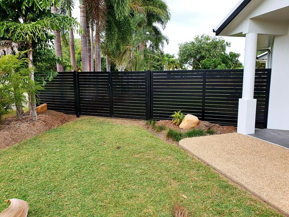 Black Horizontal Slat Fence in Front Yard With Lawn and Trees — Gate-O-Matic in Garbutt, QLD