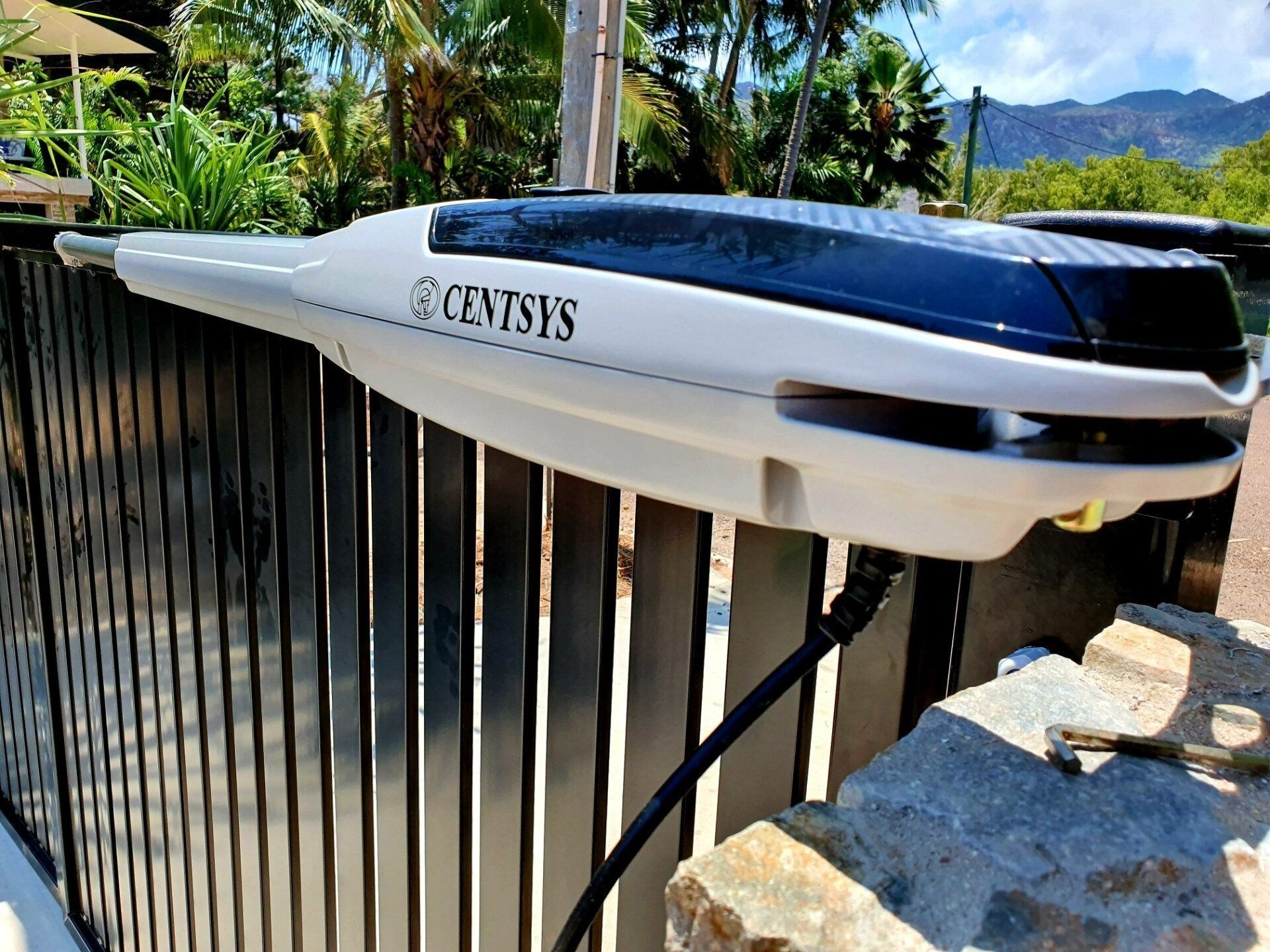 Solar-powered Centurys Gate Opener Attached to a Black Metal Gate — Gate-O-Matic in Garbutt, QLD