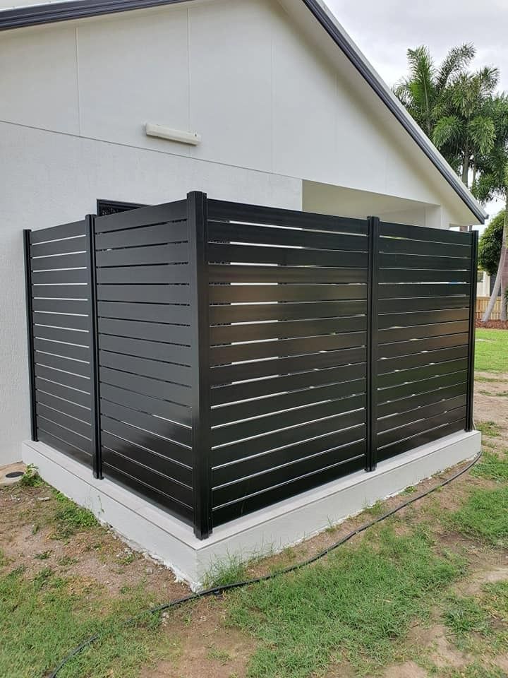 Black Slat Fence in Front of a White Building Corner — Gate-O-Matic in Garbutt, QLD