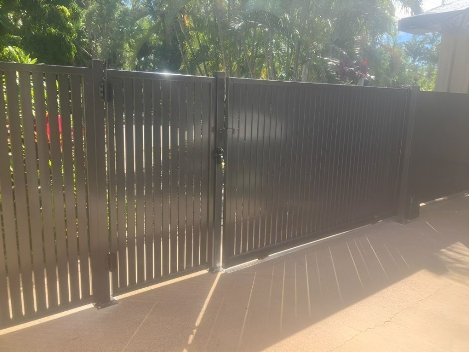 Black Slatted Fence With a Gate, in an Outdoor Setting — Gate-O-Matic in Garbutt, QLD