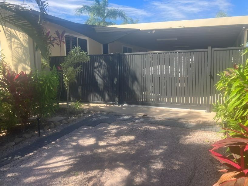 A House With a Black Gate, Surrounded by Green Tropical Plants — Gate-O-Matic in Garbutt, QLD