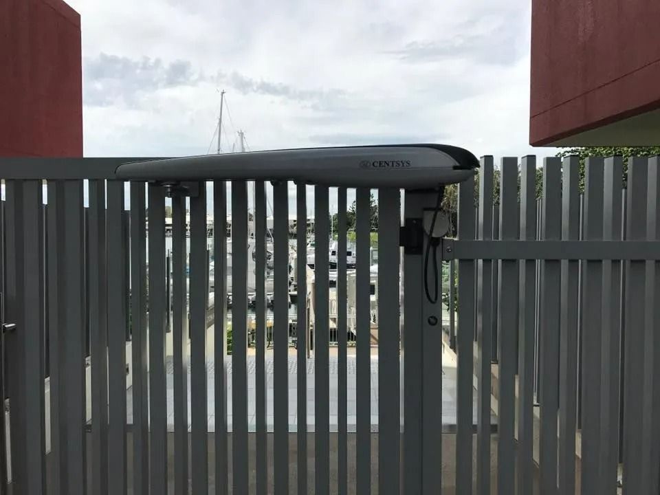 Grey Metal Gate With Automatic Arm Opener, Cloudy Sky Background — Gate-O-Matic in Garbutt, QLD