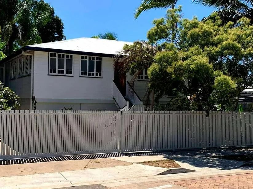 White House With White Fence and Green Trees on a Sunny Day — Gate-O-Matic in Garbutt, QLD