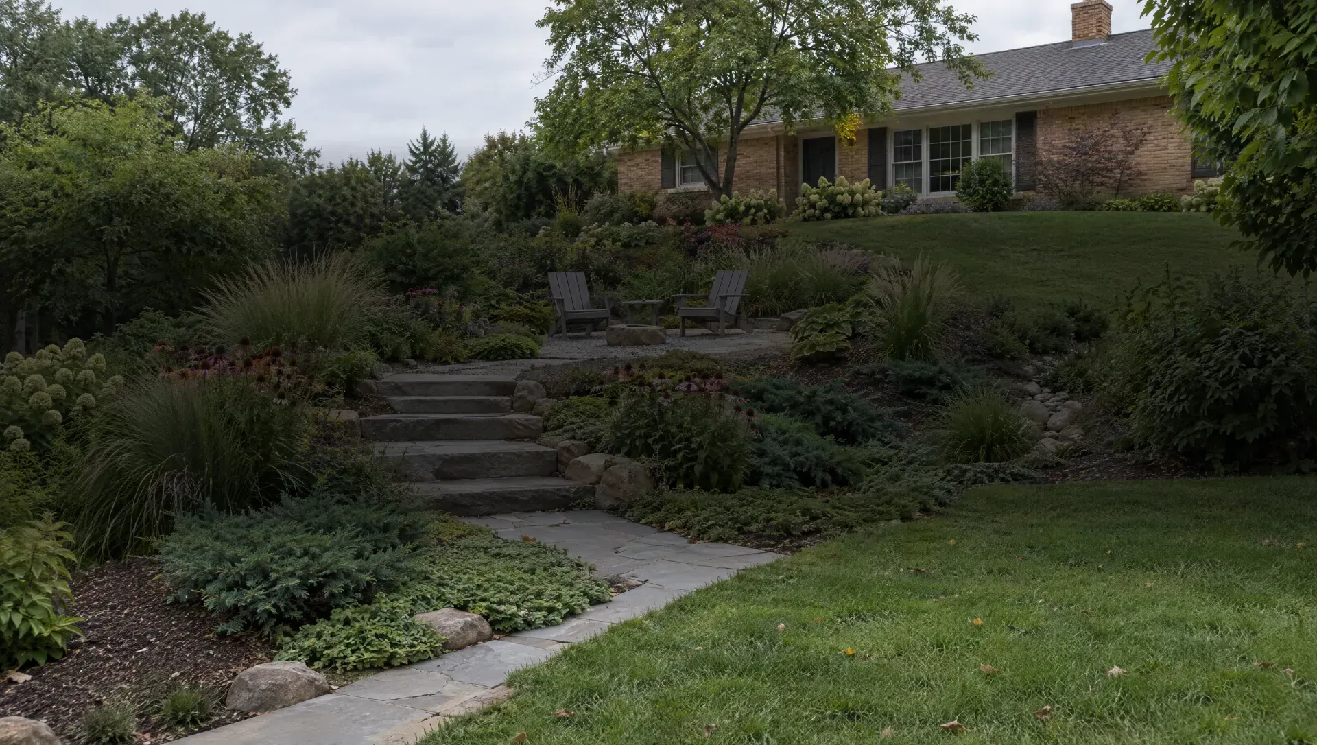 Illustration of a sloped yard with stone steps, layered planting and a small gravel seating area.
