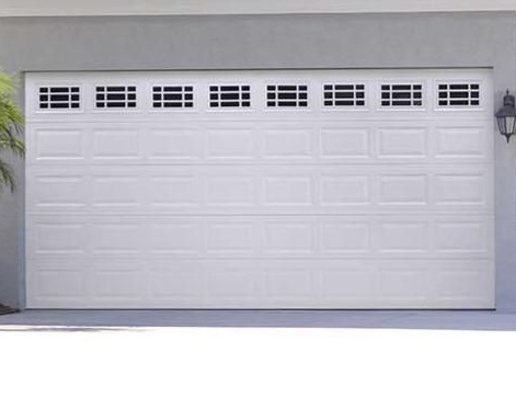 Two matching white residential garage doors installed on a multi-car garage in Bartram Park.