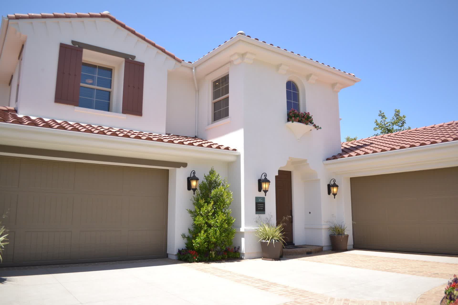 Modern two-story Florida home with professional hurricane-rated double garage doors.