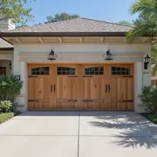 A home with brown carriage style garage doors.