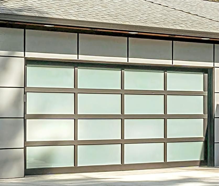 Modern black aluminum garage door with frosted glass window panels installed in Southside Jacksonville.