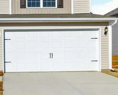 New white steel raised-panel garage door on a suburban home in Nocatee, FL.