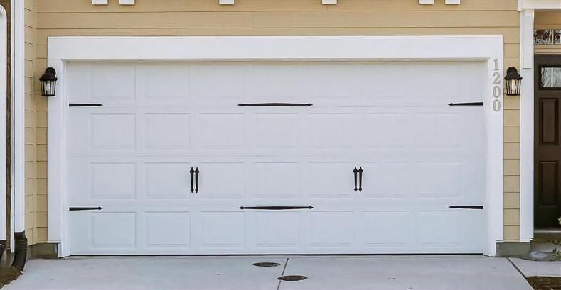 White raised-panel residential garage door installation in the Argyle Forest neighborhood of Jacksonville.