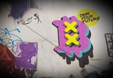 Graffiti: Pink Bitcoin symbol with yellow