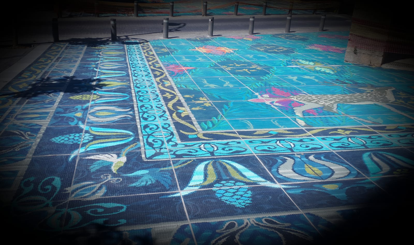 Blue tiled floor with floral and animal designs.
