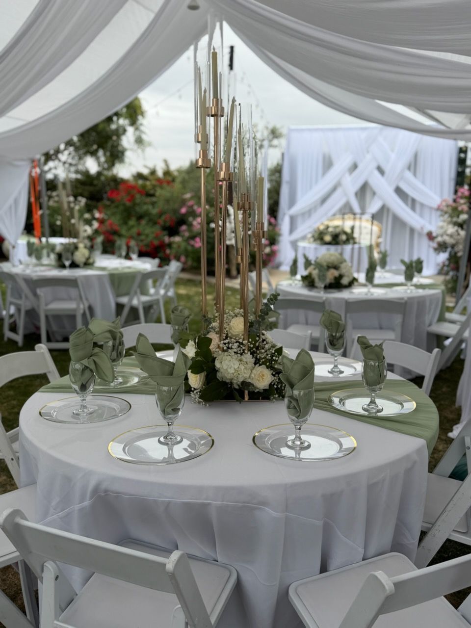 Caterers serving food at an outdoor event with plates of appetizers.