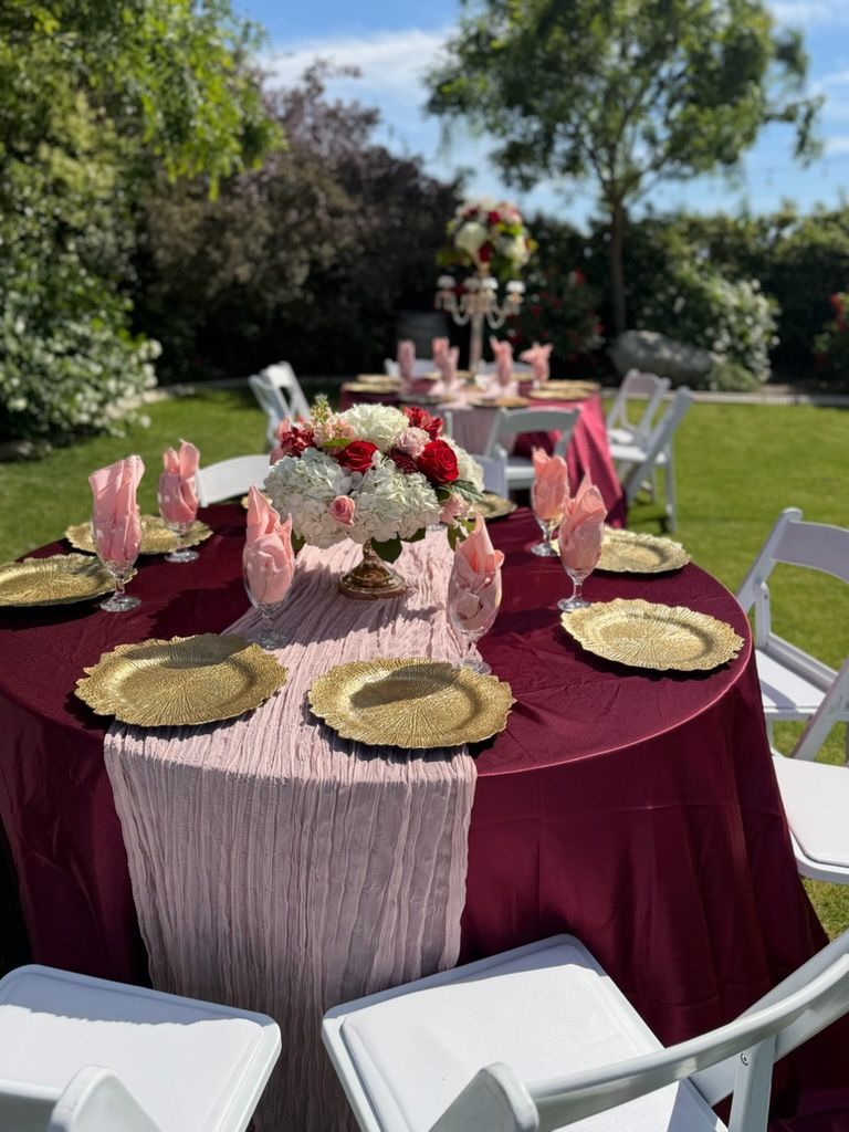 Caterers serving food at an outdoor event with plates of appetizers.