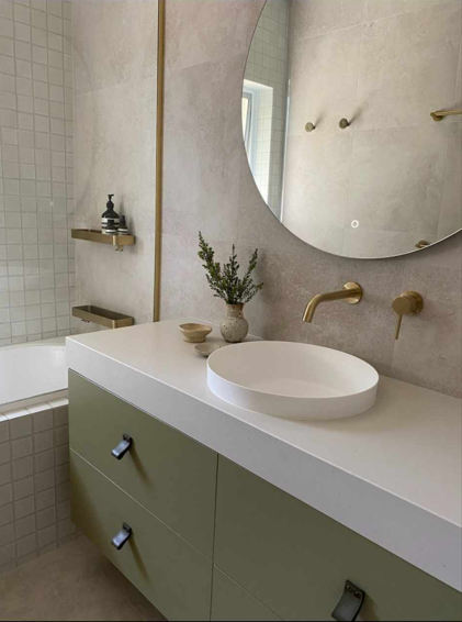 A bathroom with a sink , mirror and bathtub.