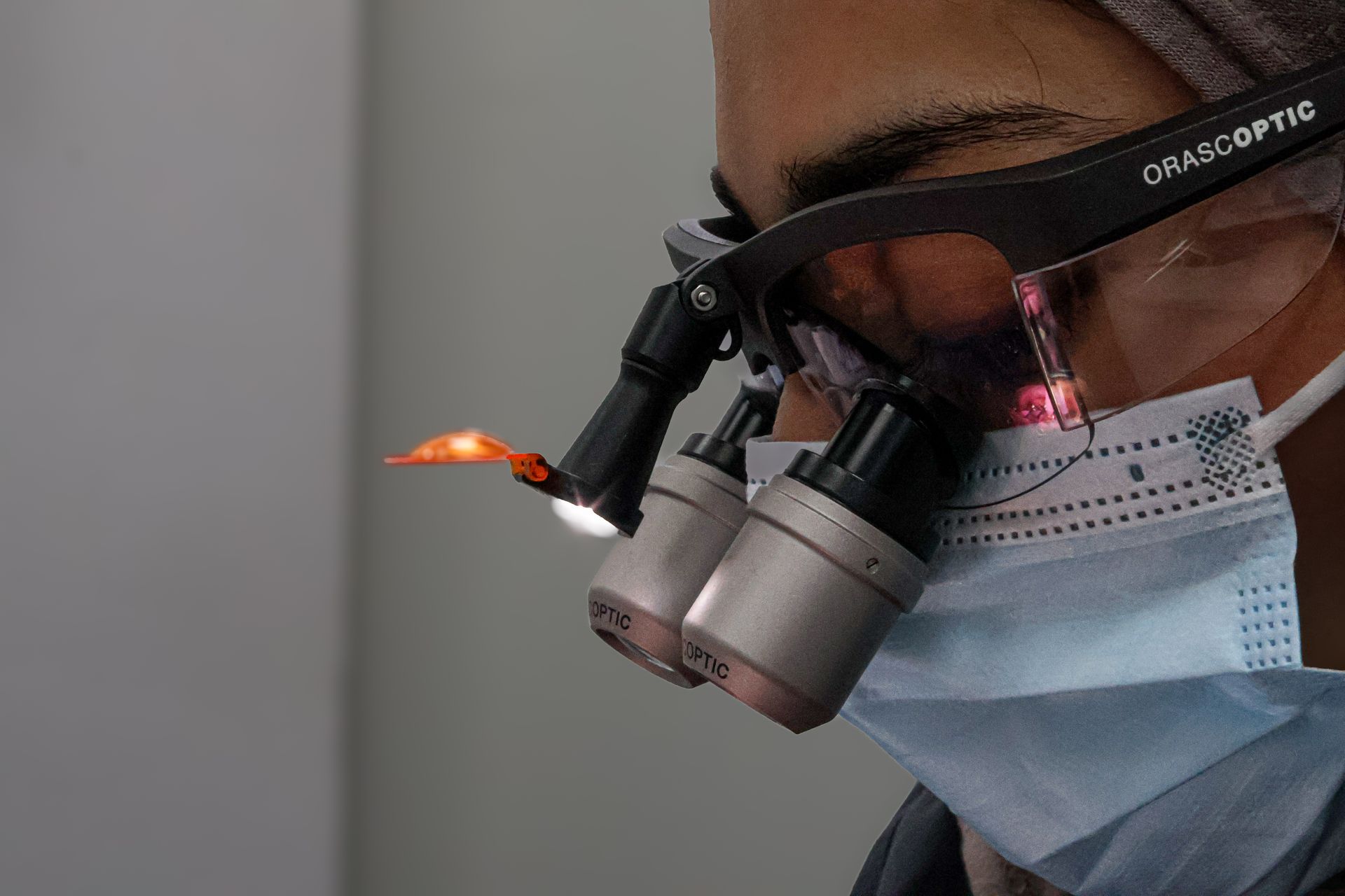 a man is performing dental care for a patient. 