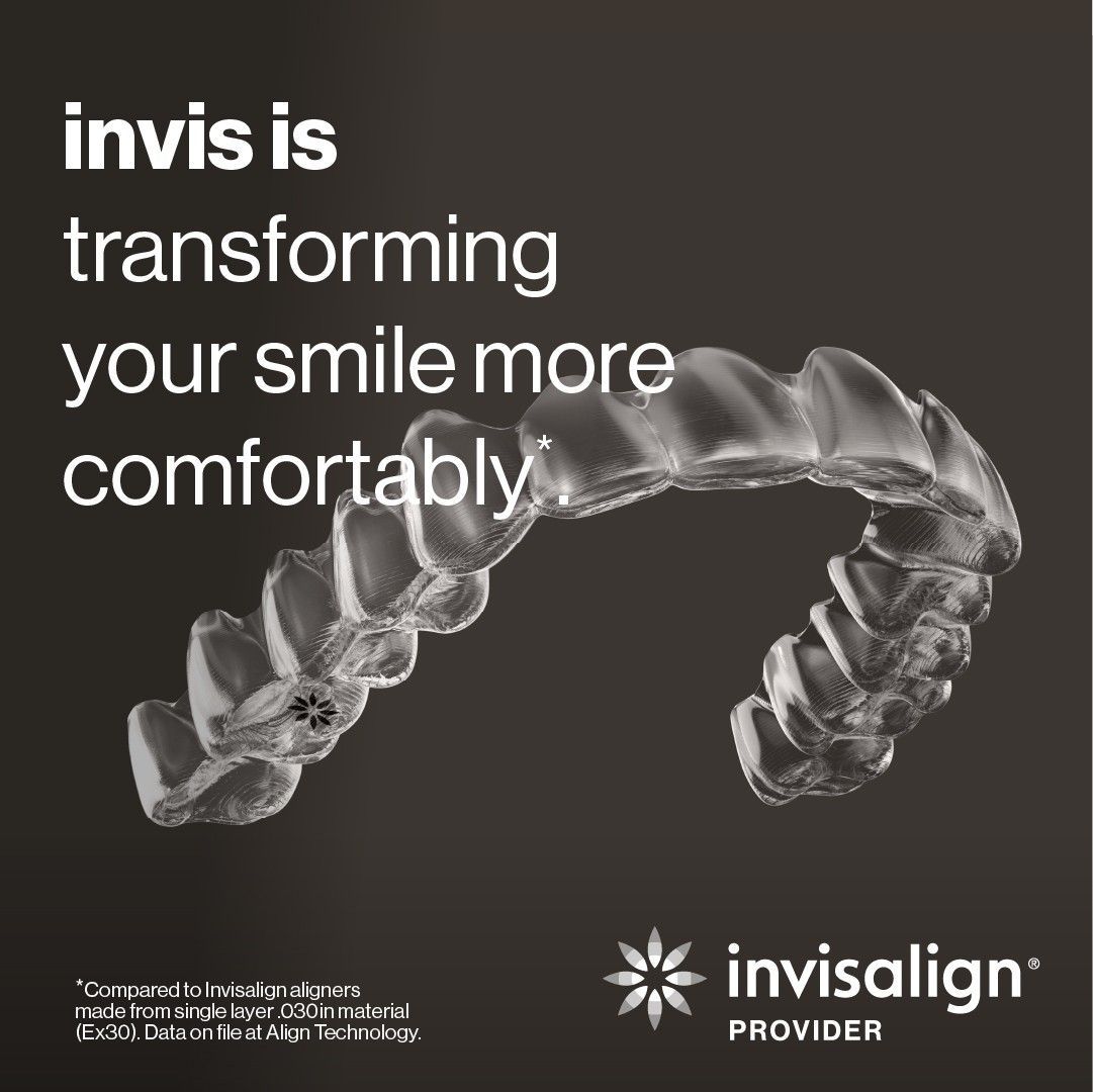 Clear, removable  Invisalign aligners on a dark background.