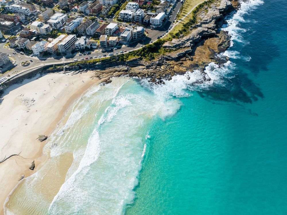 An Aerial View of a Beach and Ocean With Waves Crashing on the Shore — Bondi Removals and Taxi Trucks in Maroubra, NSW