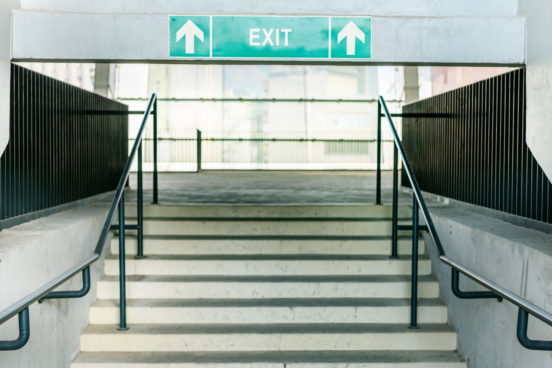 A tired business owner stands in front of an exit, thinking about the future of their business.